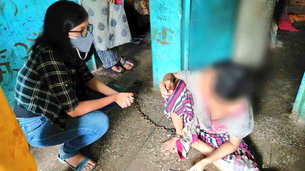 Woman bound in iron chains, held captive
