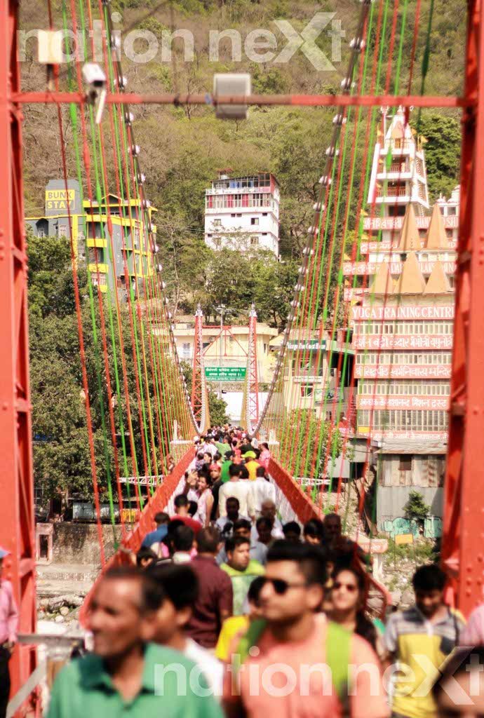 Lakshman Jhula, the famous 450-feet long hanging bridge across Ganga, is about 3 km from the main township of Rishikesh