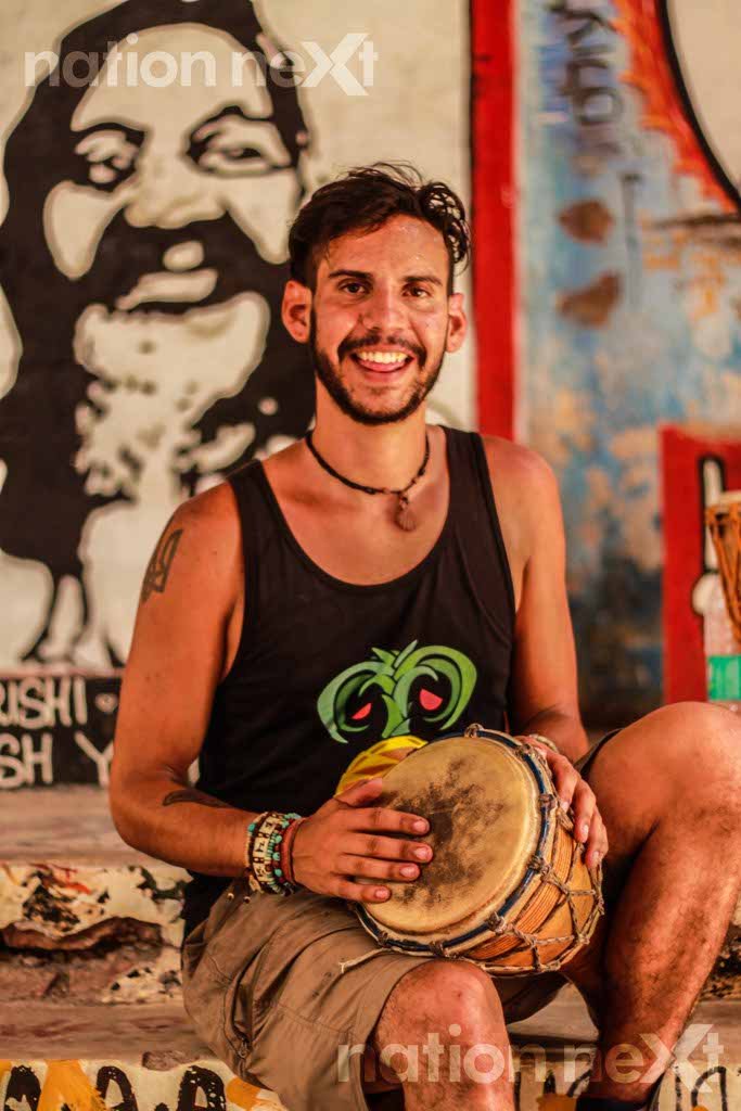 A foreign tourist plays Djembe at the Beatles Ashram in Rishikesh