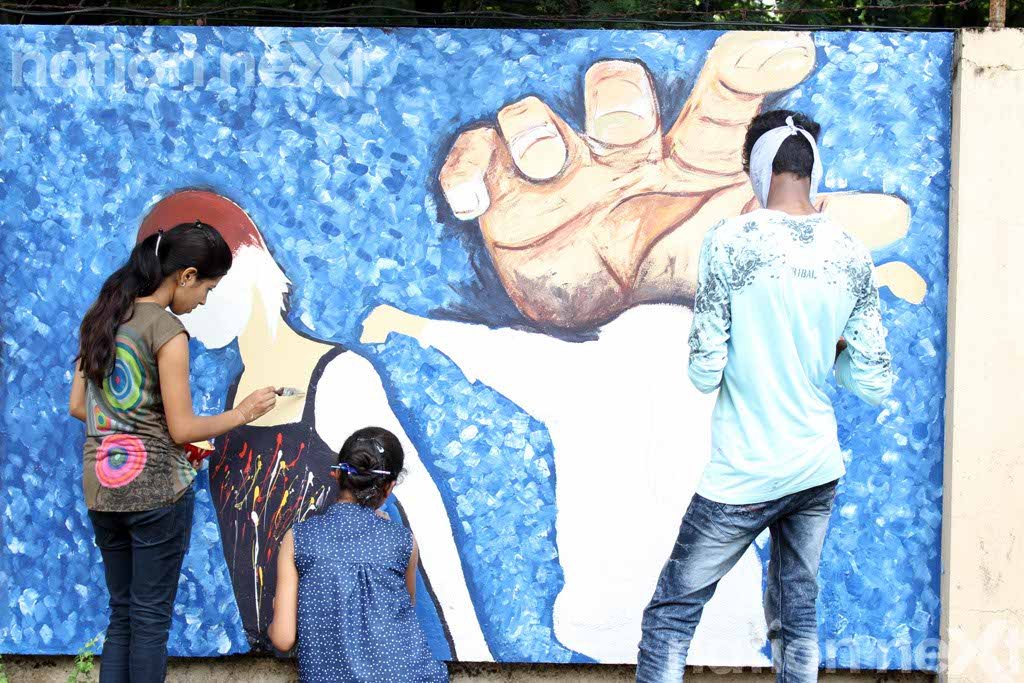 Rajshree Upadhye, Neha Tripathi and Sumiran Pandey while making a painting at Graffiti Wall, a wall designing programme organized at IIID Design Yatra. They wanted to raise the issue of child labour through their painting