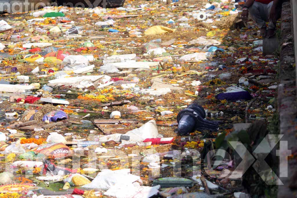 WHOM SHOULD I ASK FOR HELP? A Shiv Lingam floating on Futala Lake, Nagpur, which is covered with garbage and filth