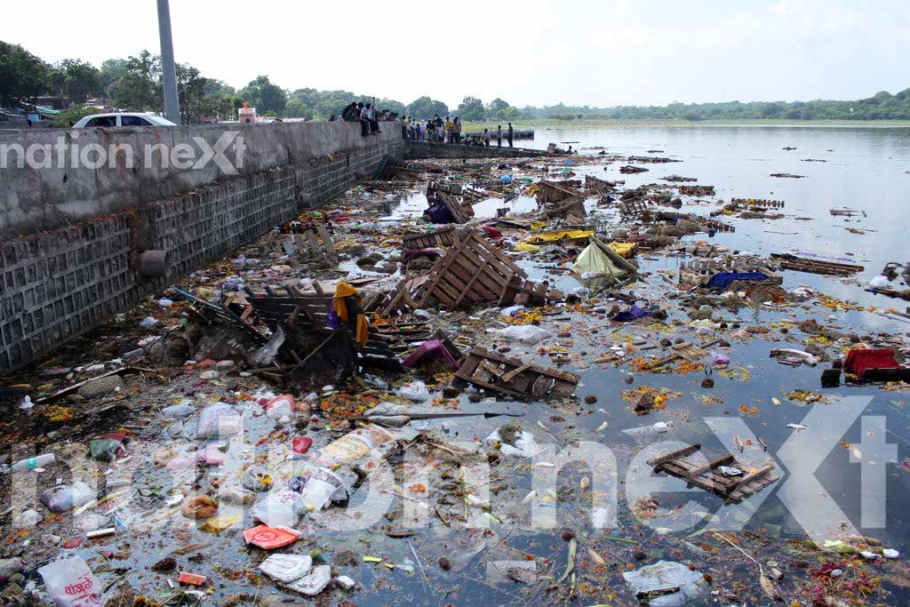 Waste of flowers, wooden boxes, plastic bags and thermocol decorations thrown carelessly in Futala lake, Nagpur