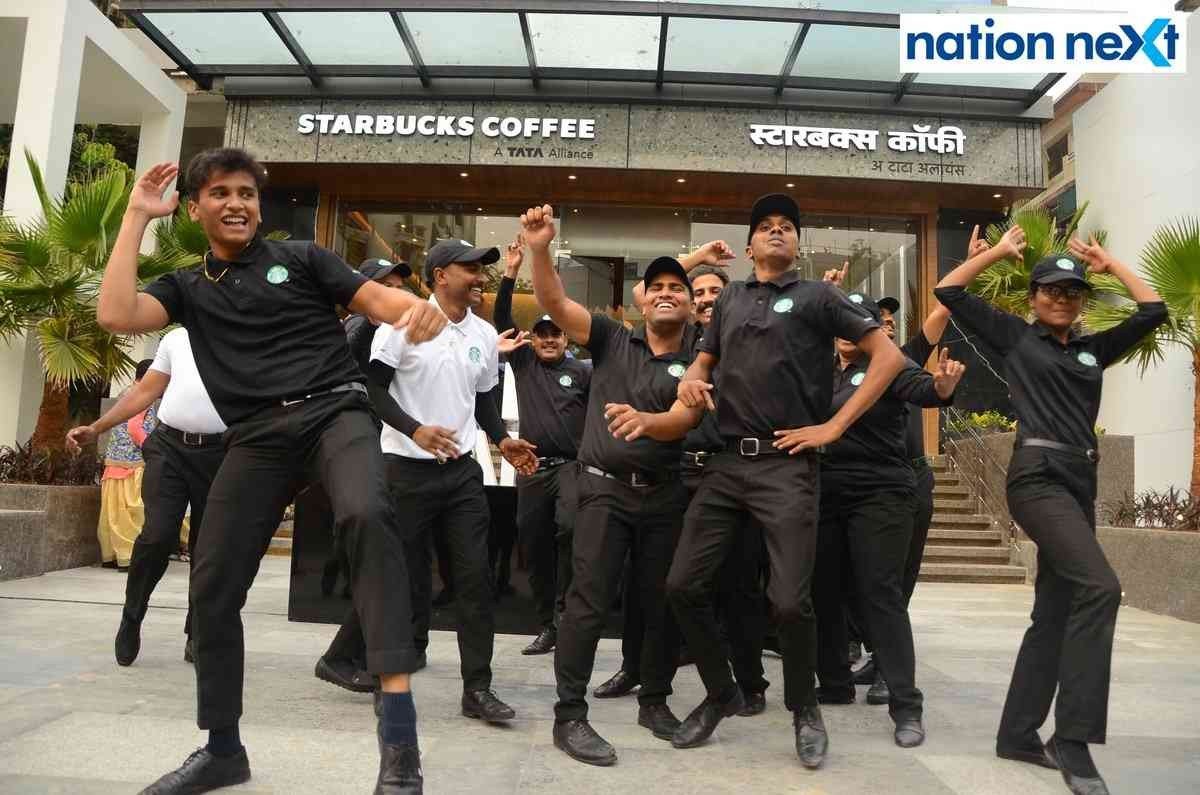 Starbucks staff shake a leg during the launch event of Tata Starbucks in Nagpur